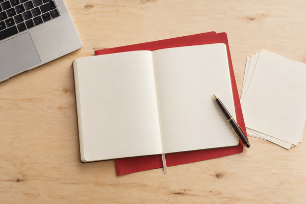 Notebook and laptop on a desk — B Corp process