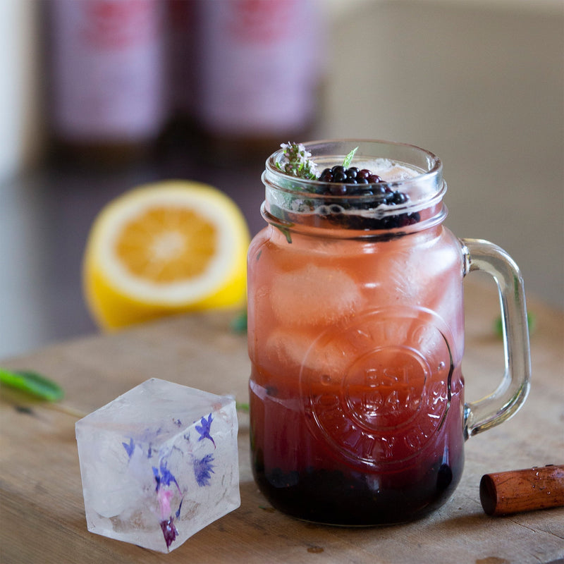 Muddled blackberry and plum spritzer cocktail